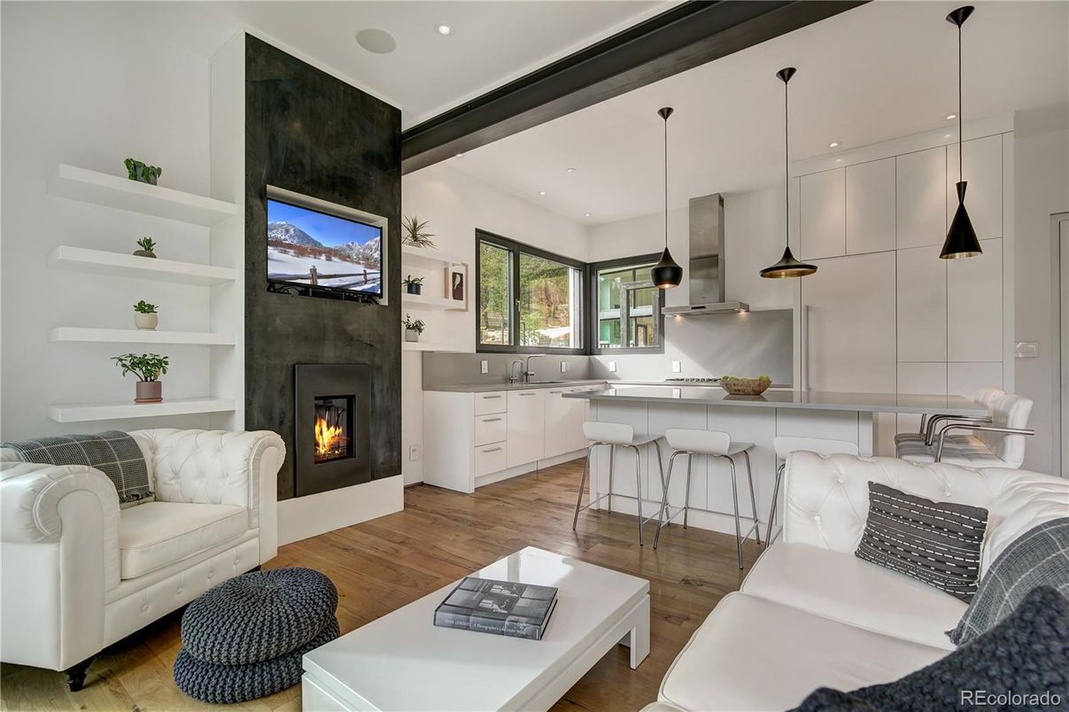 Fireplace, Interior, Kitchen, Living room, Pendant Lights, Recessed Lighting, Stainless Steel Appliances, Wood Texture Flooring