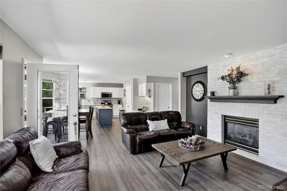Dining room, Fireplace, Interior, Kitchen, Living room, Recessed Lighting, Stone Walls, Wood Texture Flooring
