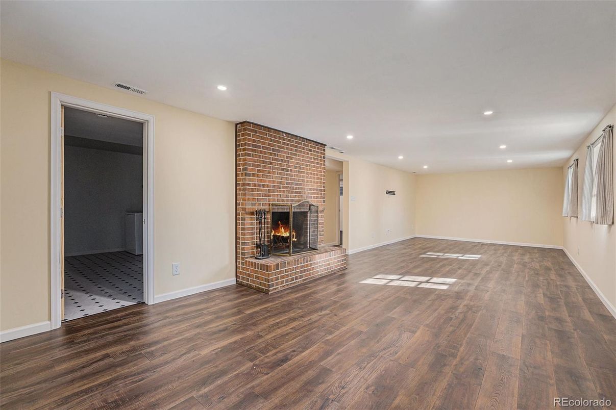 Empty room, Fireplace, Interior, Recessed Lighting, Stone Walls, Wood Texture Flooring