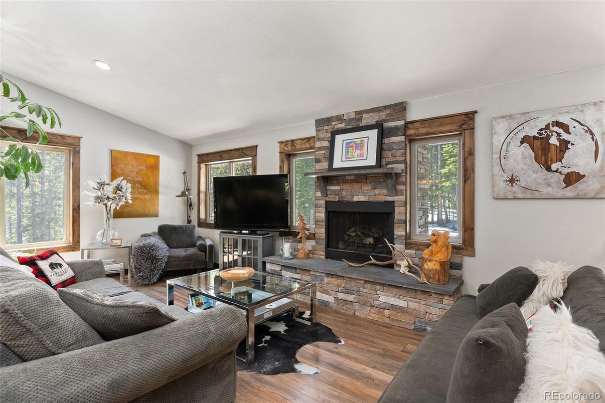 Fireplace, Interior, Living room, Recessed Lighting, Stone Walls, Wood Texture Flooring