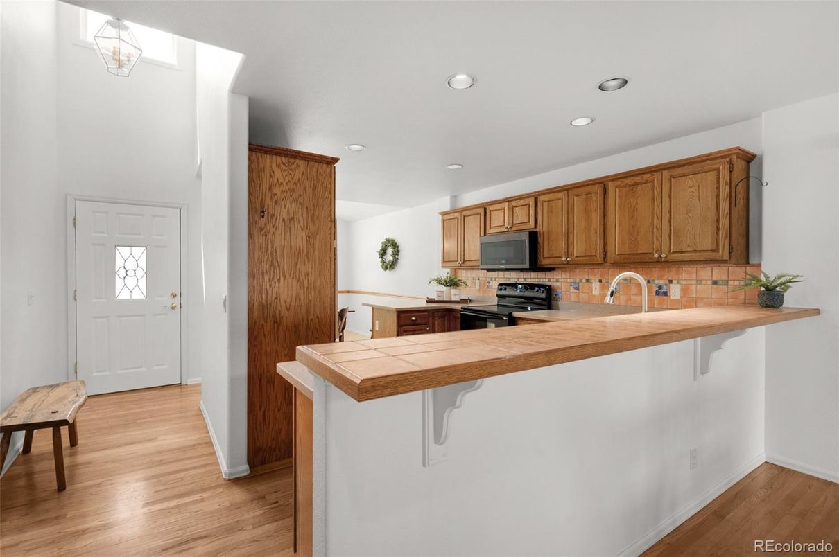 Interior, Kitchen, Recessed Lighting, Tile Countertops, Wood Texture Flooring