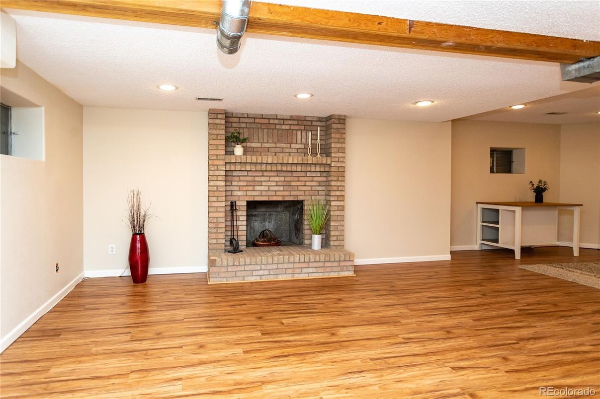 Empty room, Fireplace, Interior, Recessed Lighting, Stone Walls, Wooden Beams, Wood Texture Flooring