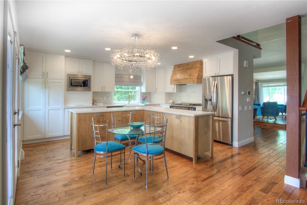 Chandelier, Dining room, Interior, Kitchen, Recessed Lighting, Stainless Steel Appliances, Wood Texture Flooring