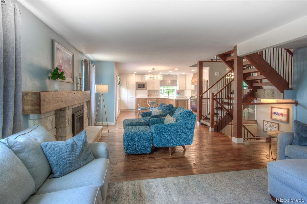 Chandelier, Fireplace, Interior, Kitchen, Living room, Recessed Lighting, Stainless Steel Appliances, Wood Texture Flooring