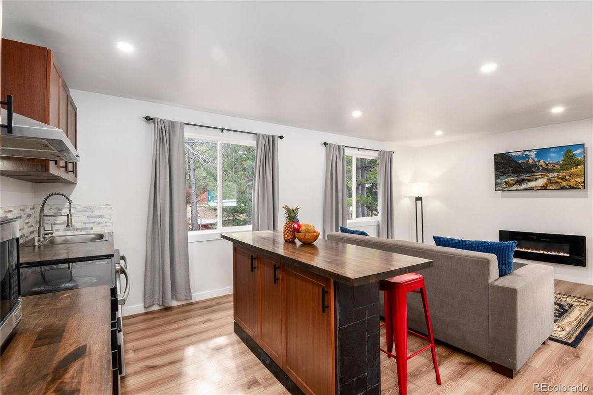 Fireplace, Interior, Kitchen, Living room, Recessed Lighting, Stainless Steel Appliances, Wood Texture Flooring