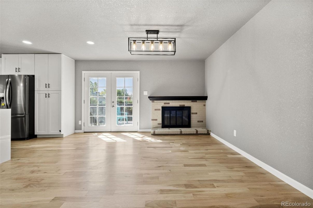 Empty room, Fireplace, Interior, Kitchen, Recessed Lighting, Wood Texture Flooring
