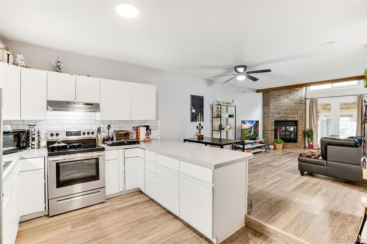Fireplace, Interior, Kitchen, Living room, Recessed Lighting, Stainless Steel Appliances, Stone Walls, Wood Texture Flooring