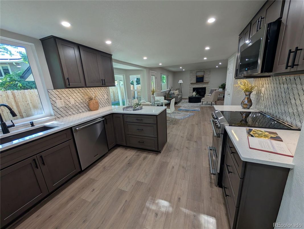 Dining room, Fireplace, Interior, Kitchen, Living room, Recessed Lighting, Stainless Steel Appliances, Wood Texture Flooring