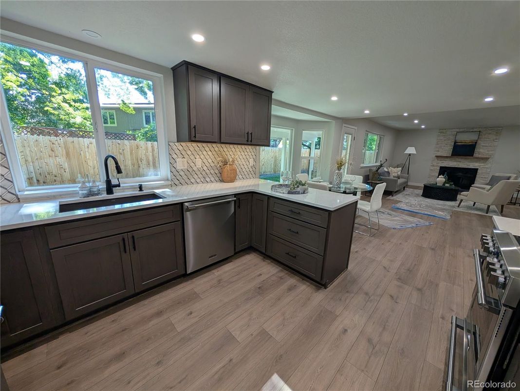 Dining room, Fireplace, Interior, Kitchen, Living room, Recessed Lighting, Stainless Steel Appliances, Stone Walls, Wood Texture Flooring
