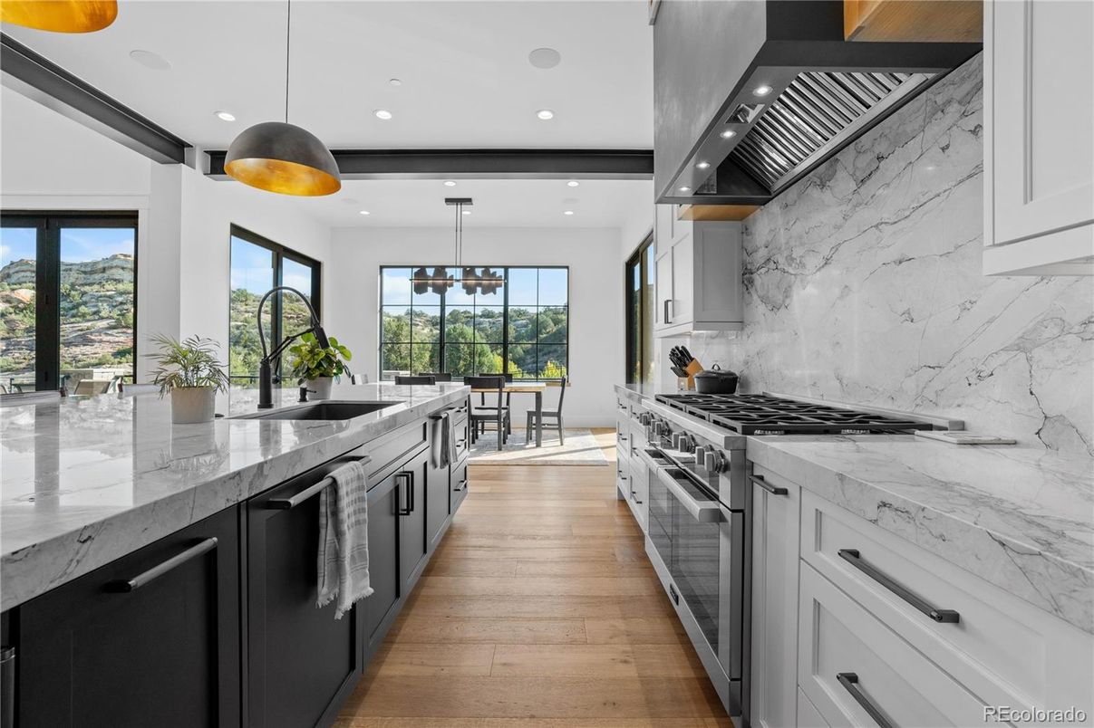 Dining room, Interior, Kitchen, Marble Walls, Pendant Lights, Recessed Lighting, Stainless Steel Appliances, Wood Texture Flooring