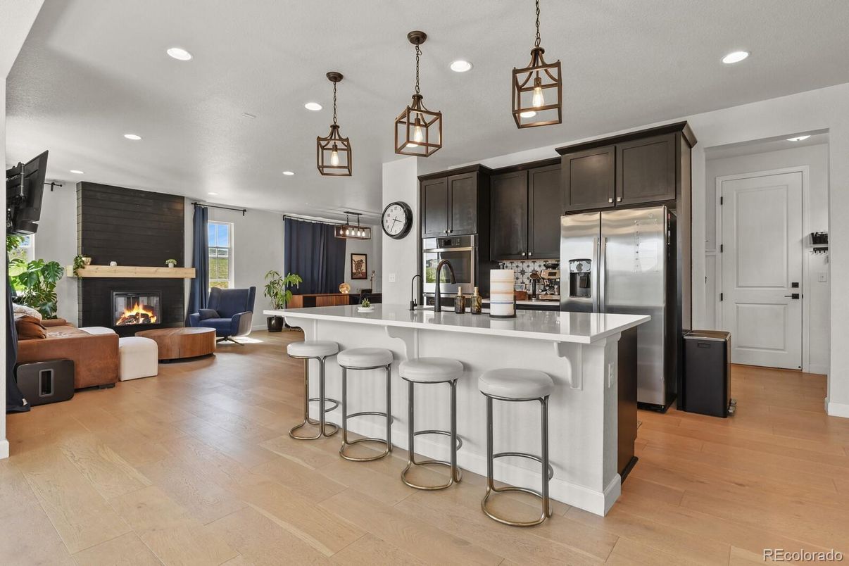 Fireplace, Interior, Kitchen, Living room, Pendant Lights, Recessed Lighting, Stainless Steel Appliances, Wood Texture Flooring