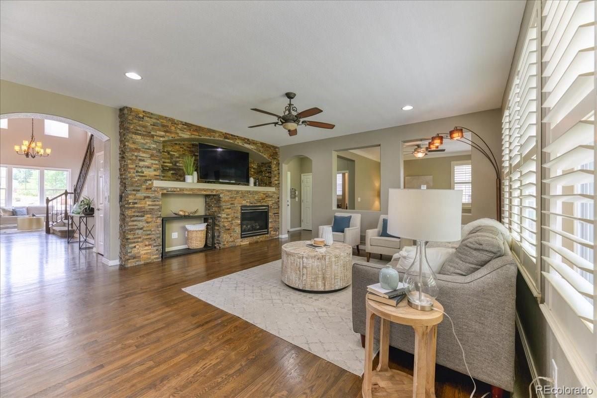 Chandelier, Fireplace, Interior, Living room, Recessed Lighting, Stone Walls, Wood Texture Flooring