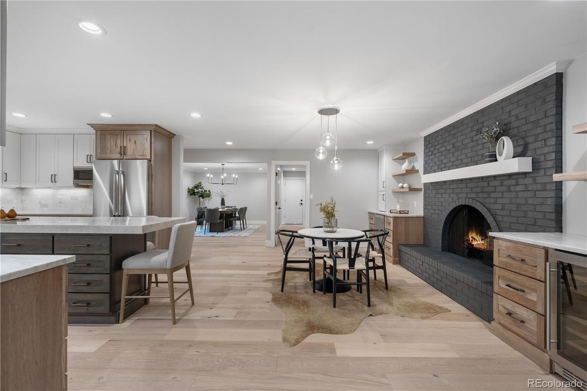 Dining room, Fireplace, Interior, Kitchen, Pendant Lights, Recessed Lighting, Stainless Steel Appliances, Stone Walls, Wood Texture Flooring
