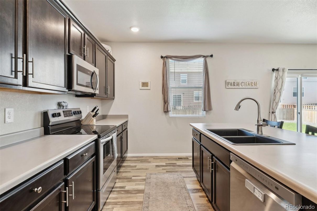 Interior, Kitchen, Recessed Lighting, Washer, Wood Texture Flooring