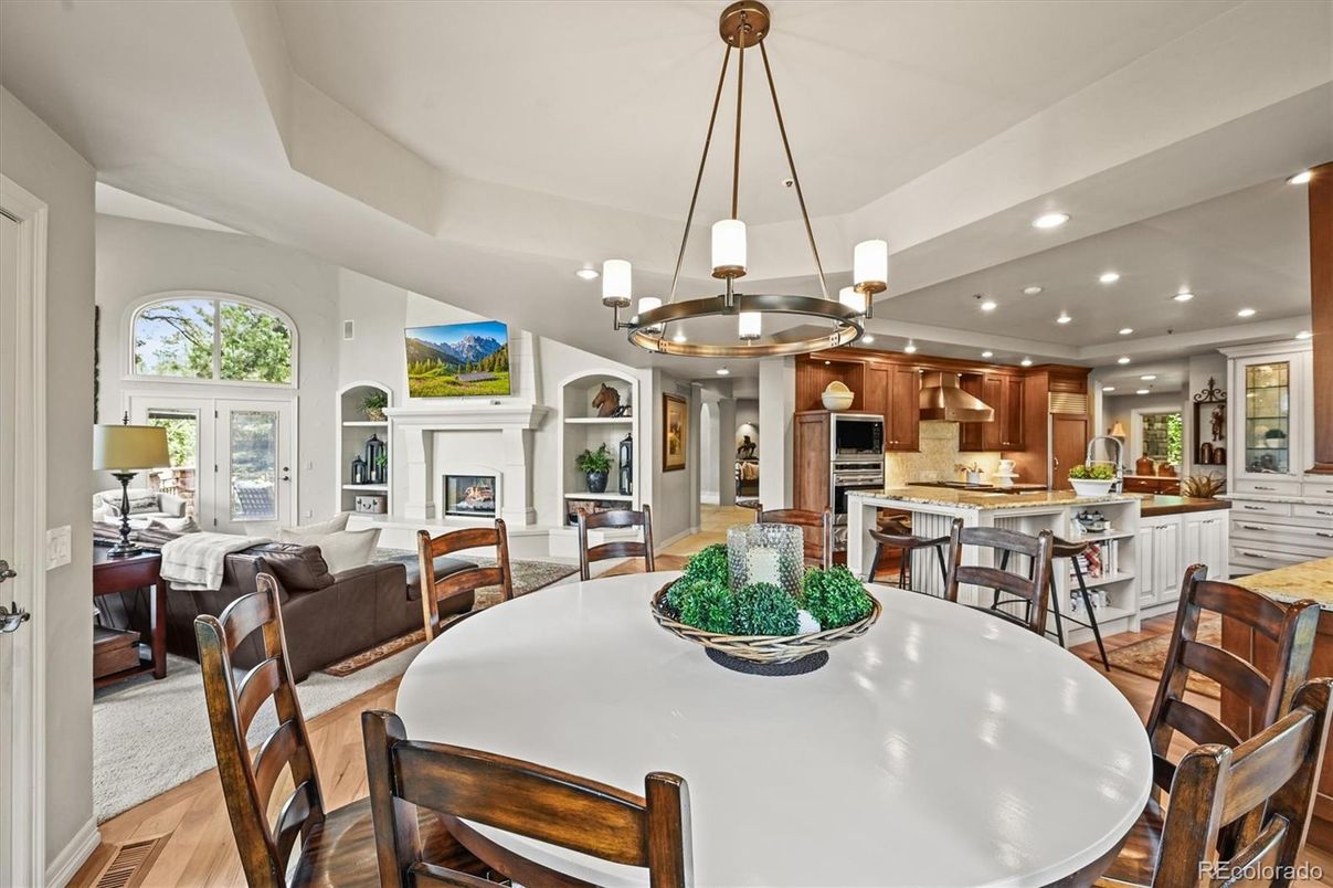 Chandelier, Dining room, Fireplace, Interior, Kitchen, Living room, Pendant Lights, Recessed Lighting, Stainless Steel Appliances, Wood Texture Flooring