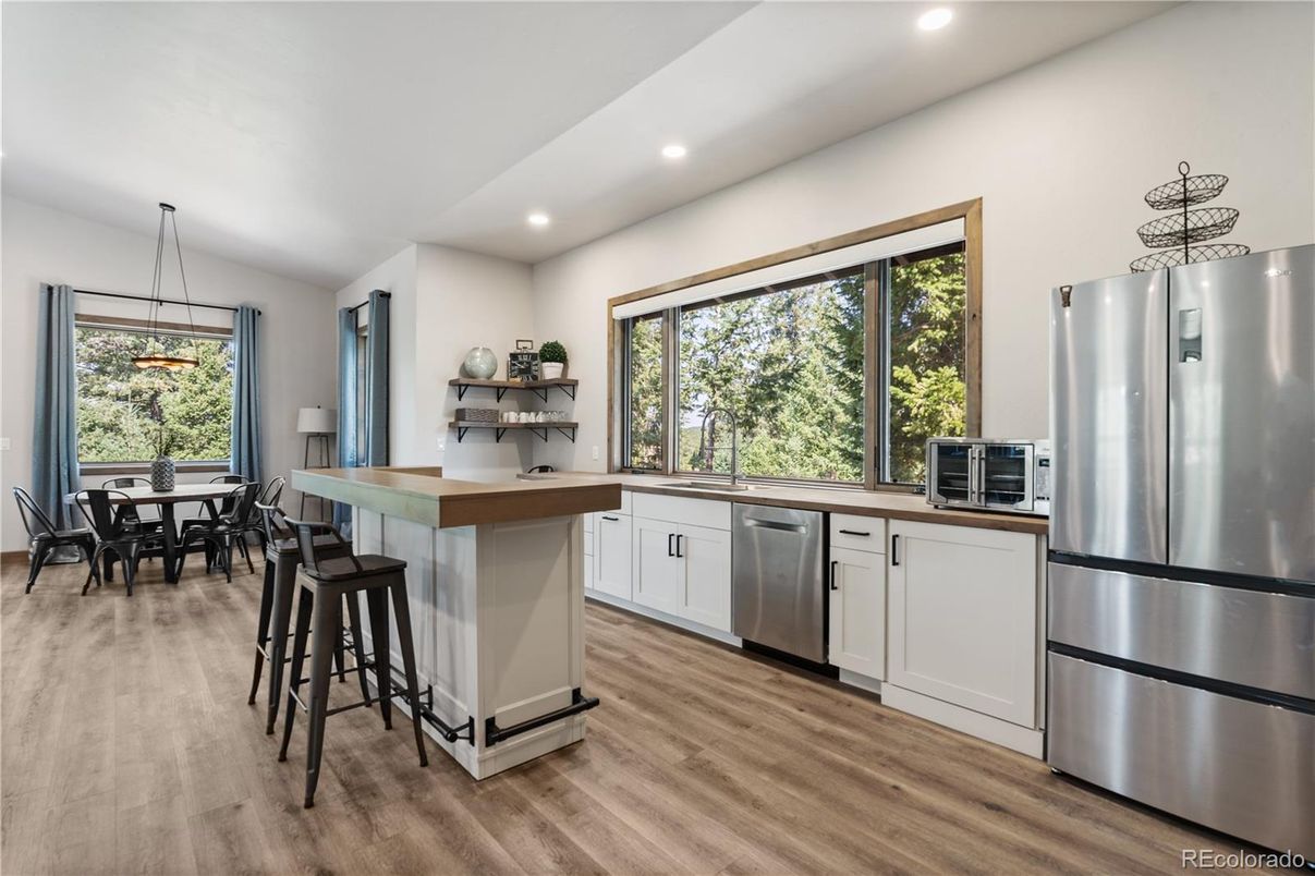 Dining room, Interior, Kitchen, Pendant Lights, Recessed Lighting, Stainless Steel Appliances, Wood Texture Flooring