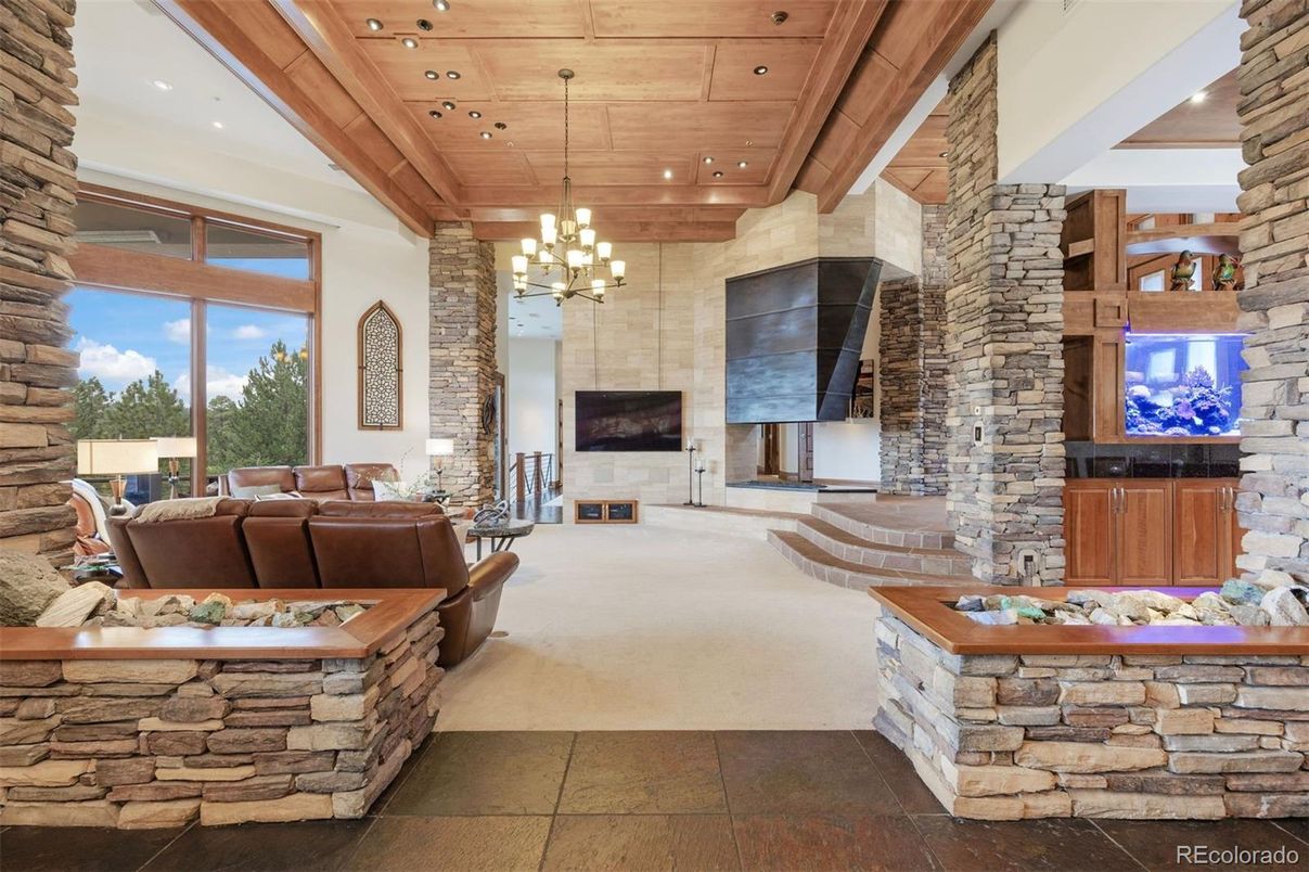Chandelier, Fireplace, Interior, Living room, Recessed Lighting, Stone Walls, Wooden Ceilings