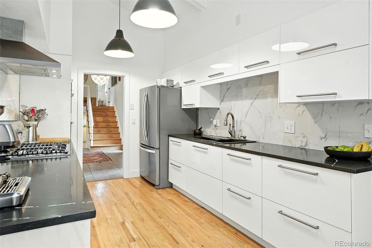 Interior, Kitchen, Marble Walls, Pendant Lights, Stainless Steel Appliances, Wood Texture Flooring