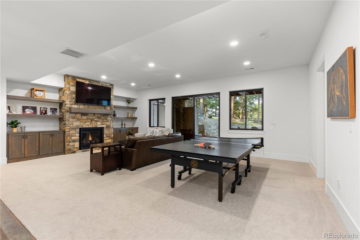 Fireplace, Game Room, Interior, Living room, Recessed Lighting, Stone Walls