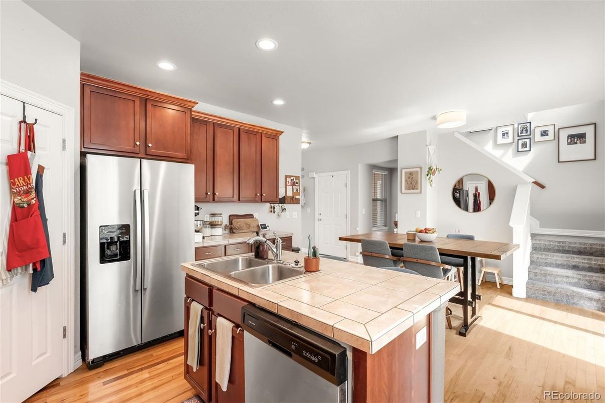 Dining room, Interior, Kitchen, Recessed Lighting, Stainless Steel Appliances, Tile Countertops, Wood Texture Flooring