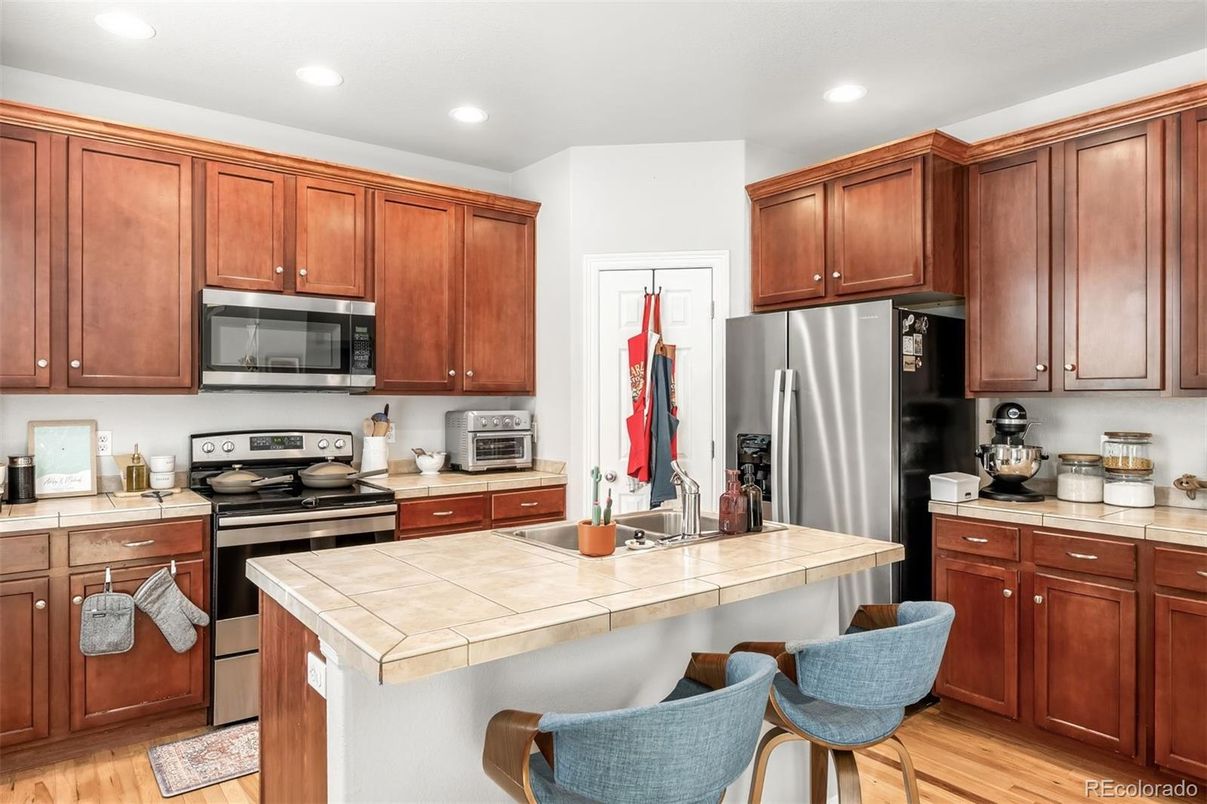 Interior, Kitchen, Recessed Lighting, Stainless Steel Appliances, Tile Countertops, Wood Texture Flooring