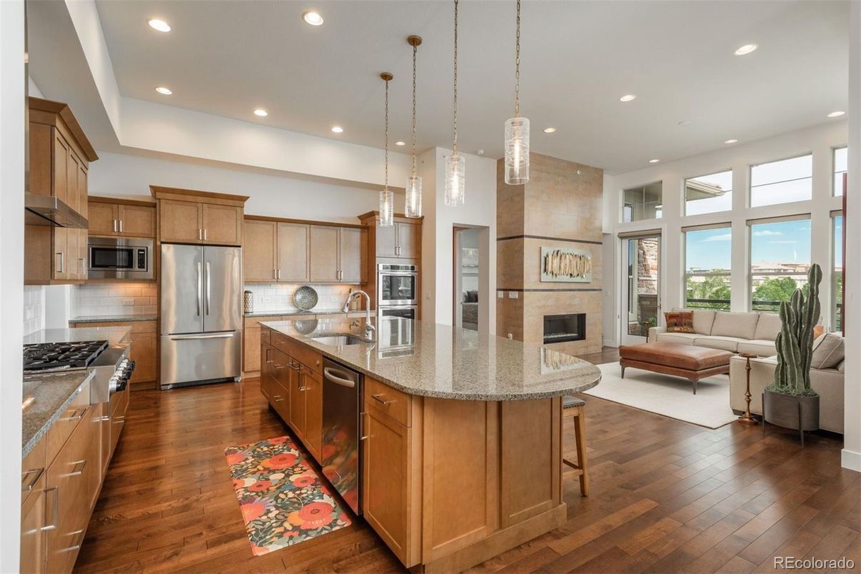 Fireplace, Interior, Kitchen, Living room, Pendant Lights, Recessed Lighting, Stainless Steel Appliances, Wood Texture Flooring