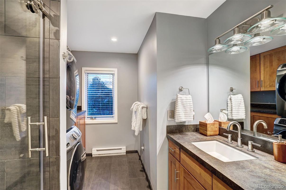 Bathroom, Glass Shower, Interior, Recessed Lighting, Washer, Wood Texture Flooring