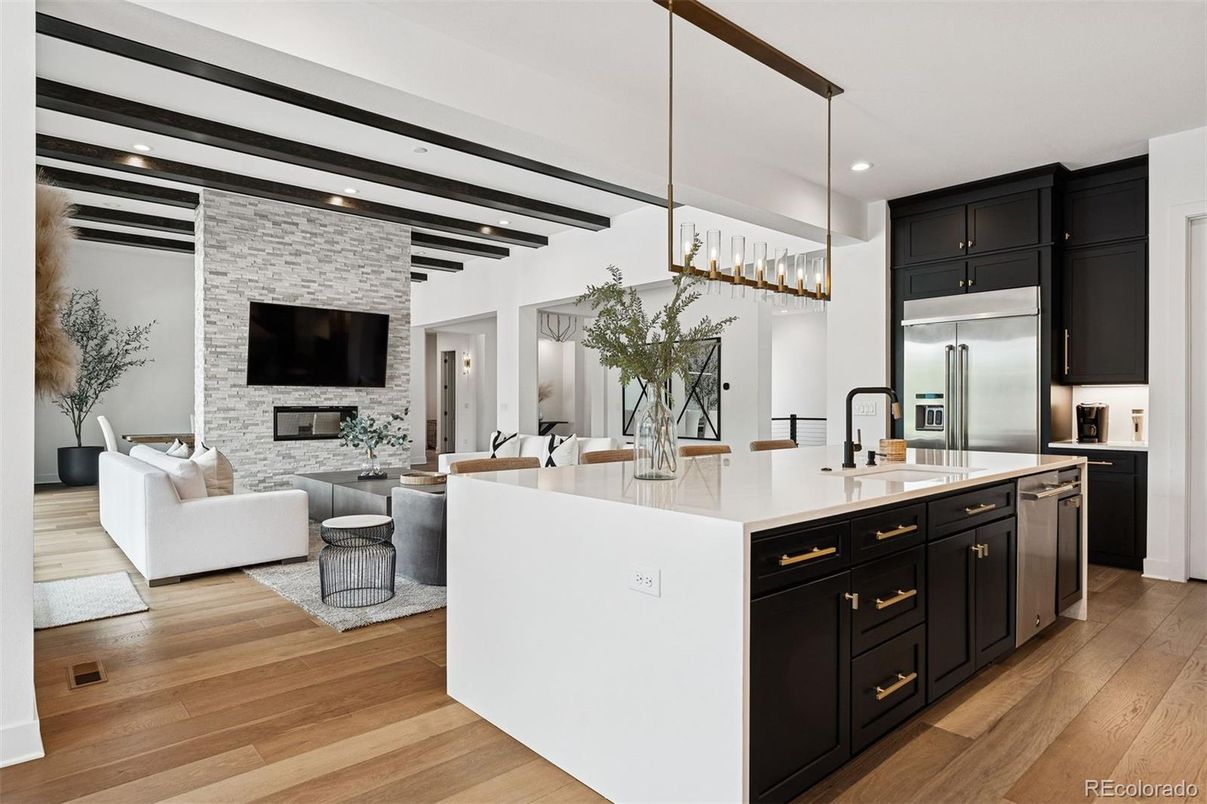 Fireplace, Interior, Kitchen, Living room, Pendant Lights, Recessed Lighting, Stainless Steel Appliances, Stone Walls, Wooden Beams, Wood Texture Flooring