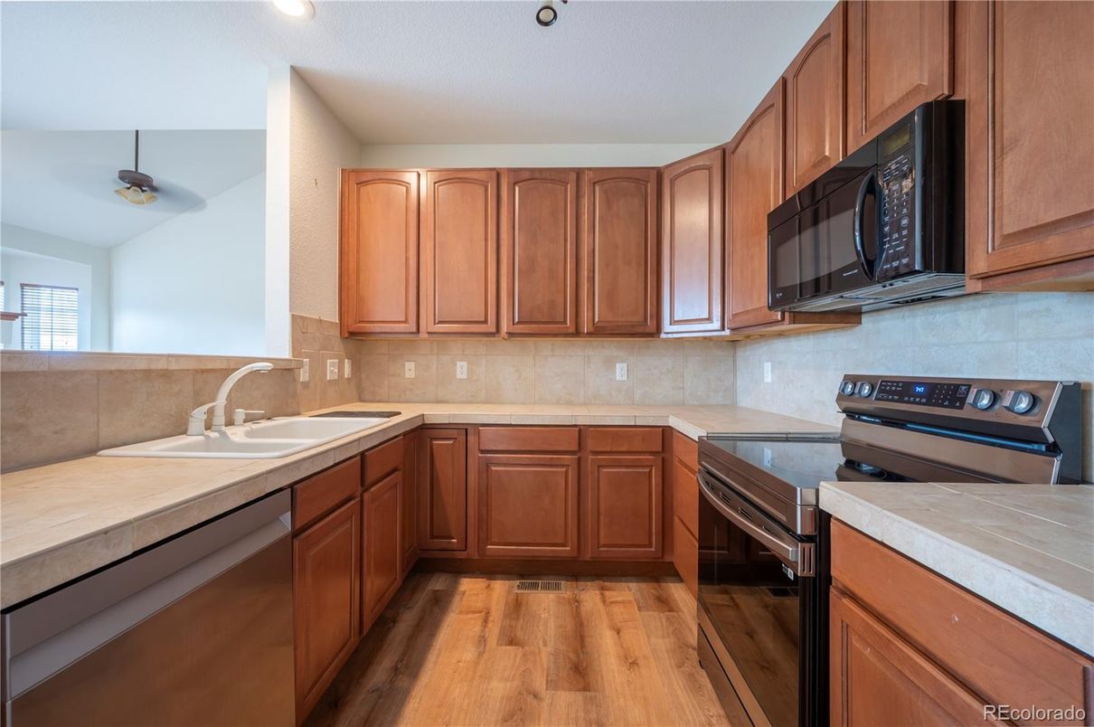 Interior, Kitchen, Recessed Lighting, Tile Countertops, Wood Texture Flooring