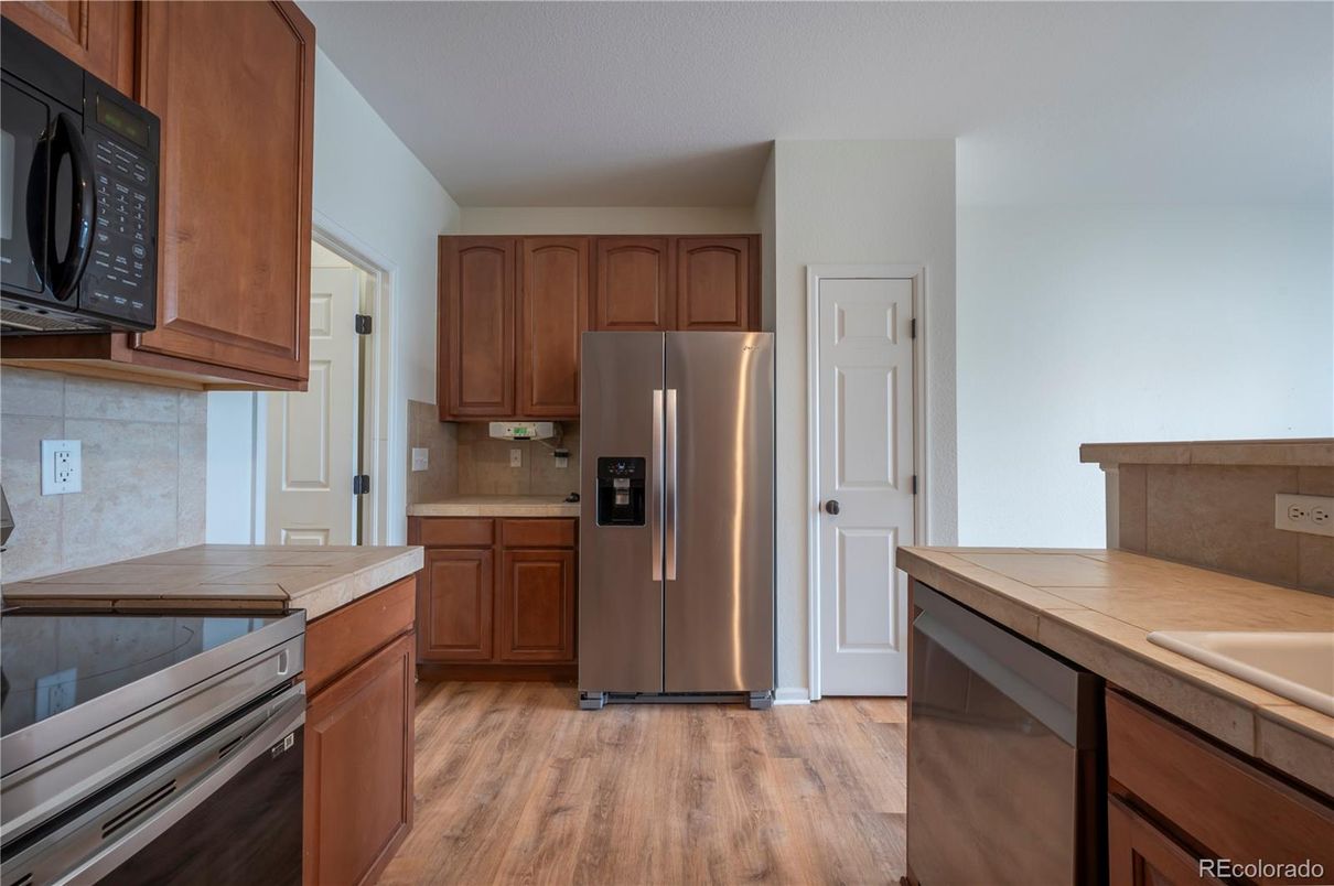 Interior, Kitchen, Stainless Steel Appliances, Tile Countertops, Wood Texture Flooring