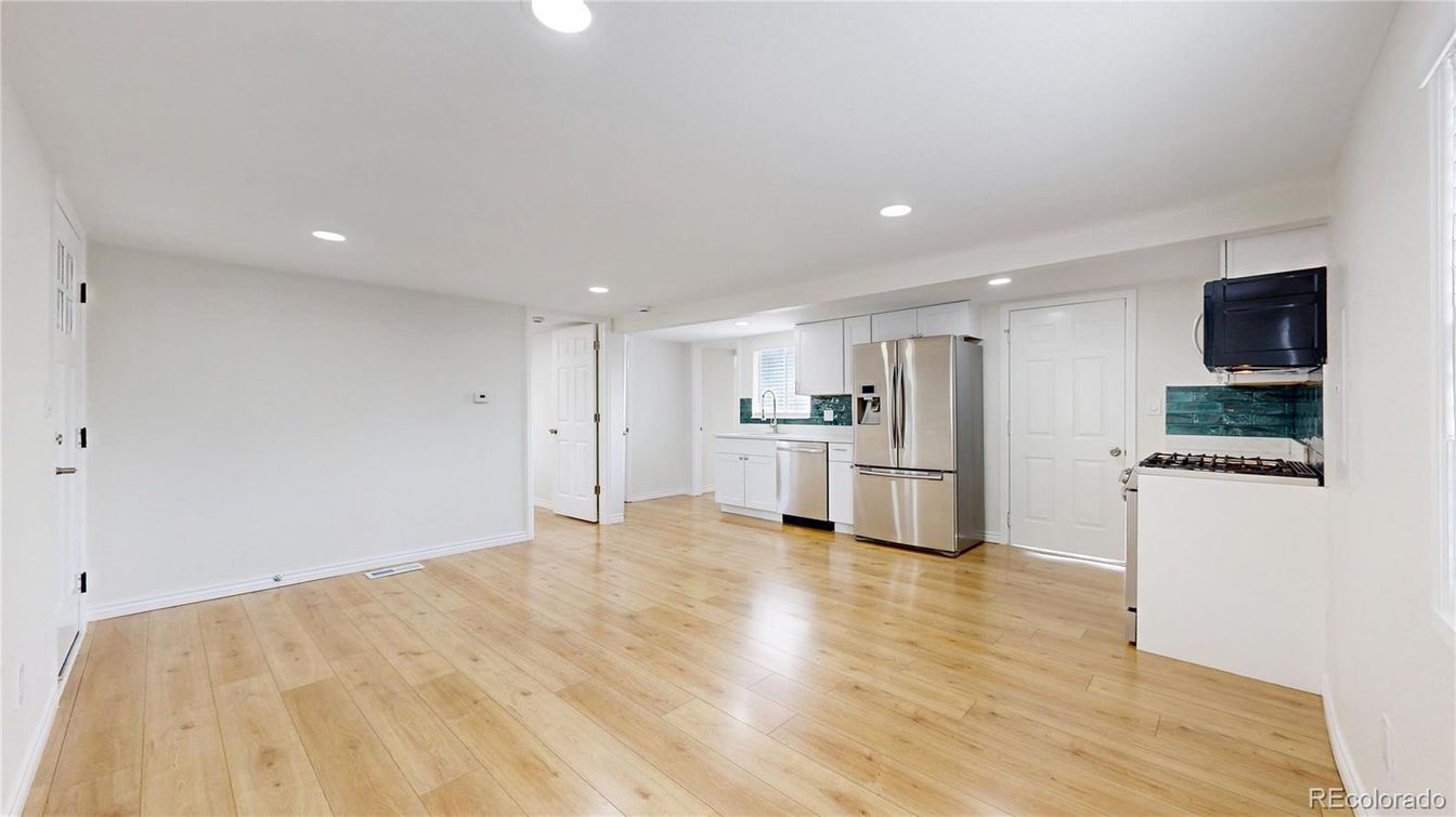 Empty room, Interior, Kitchen, Recessed Lighting, Stainless Steel Appliances, Wood Texture Flooring