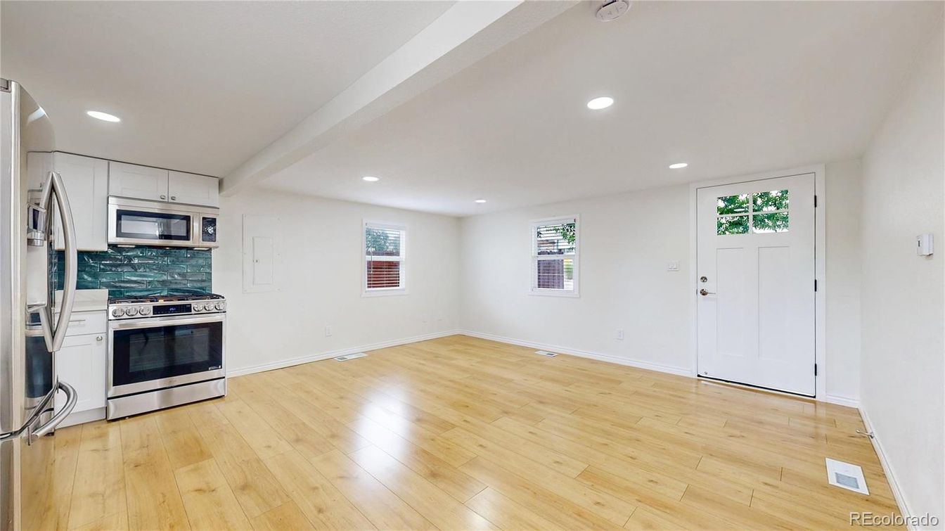 Empty room, Interior, Kitchen, Recessed Lighting, Stainless Steel Appliances, Wood Texture Flooring