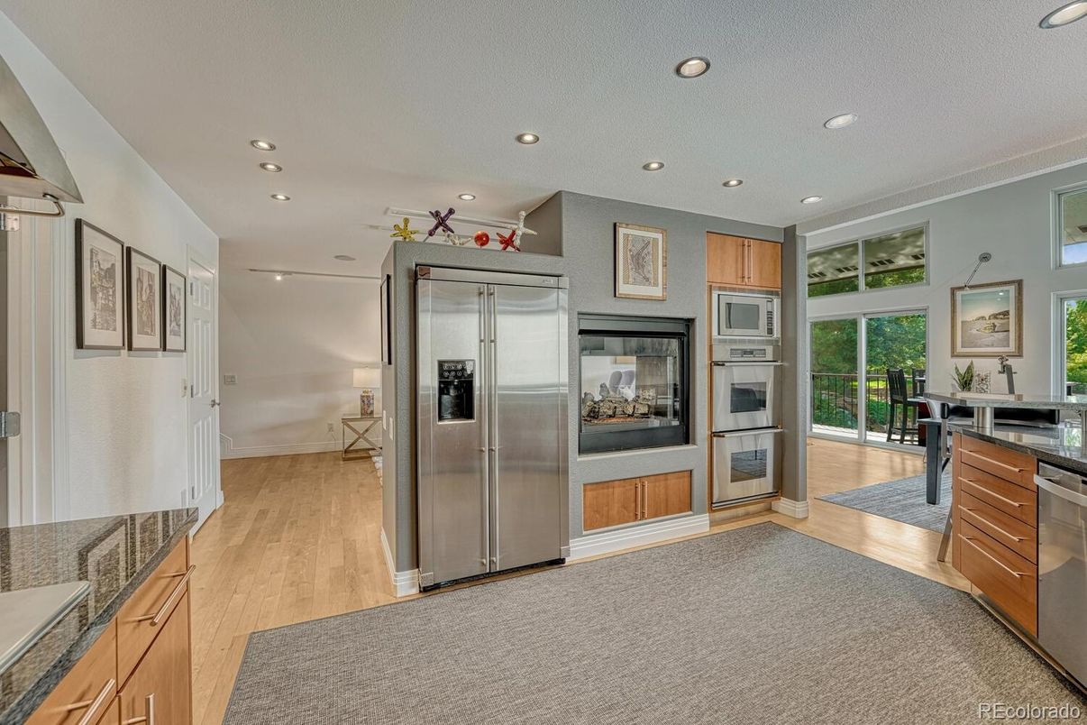 Fireplace, Interior, Kitchen, Recessed Lighting, Stainless Steel Appliances, Wood Texture Flooring