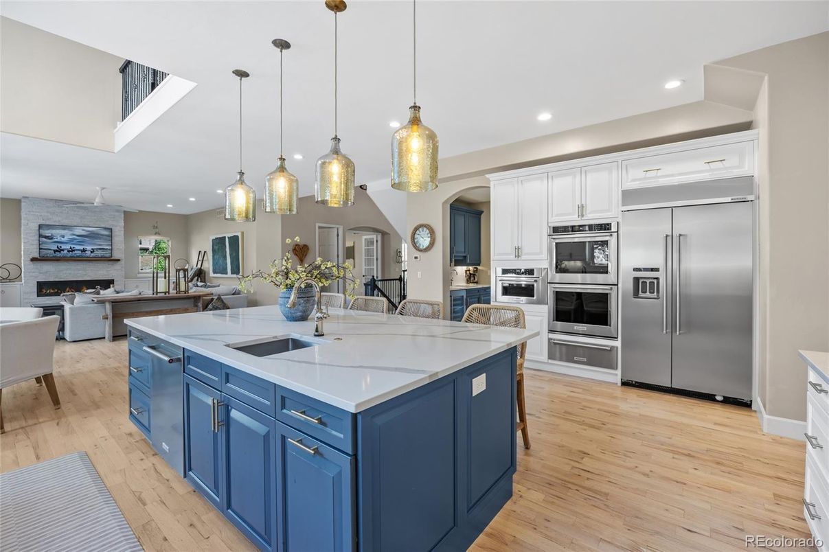 Fireplace, Interior, Kitchen, Living room, Pendant Lights, Recessed Lighting, Stainless Steel Appliances, Wood Texture Flooring
