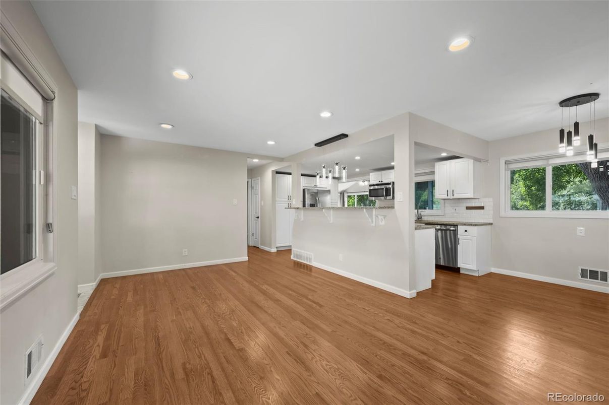 Empty room, Interior, Kitchen, Pendant Lights, Recessed Lighting, Stainless Steel Appliances, Wood Texture Flooring