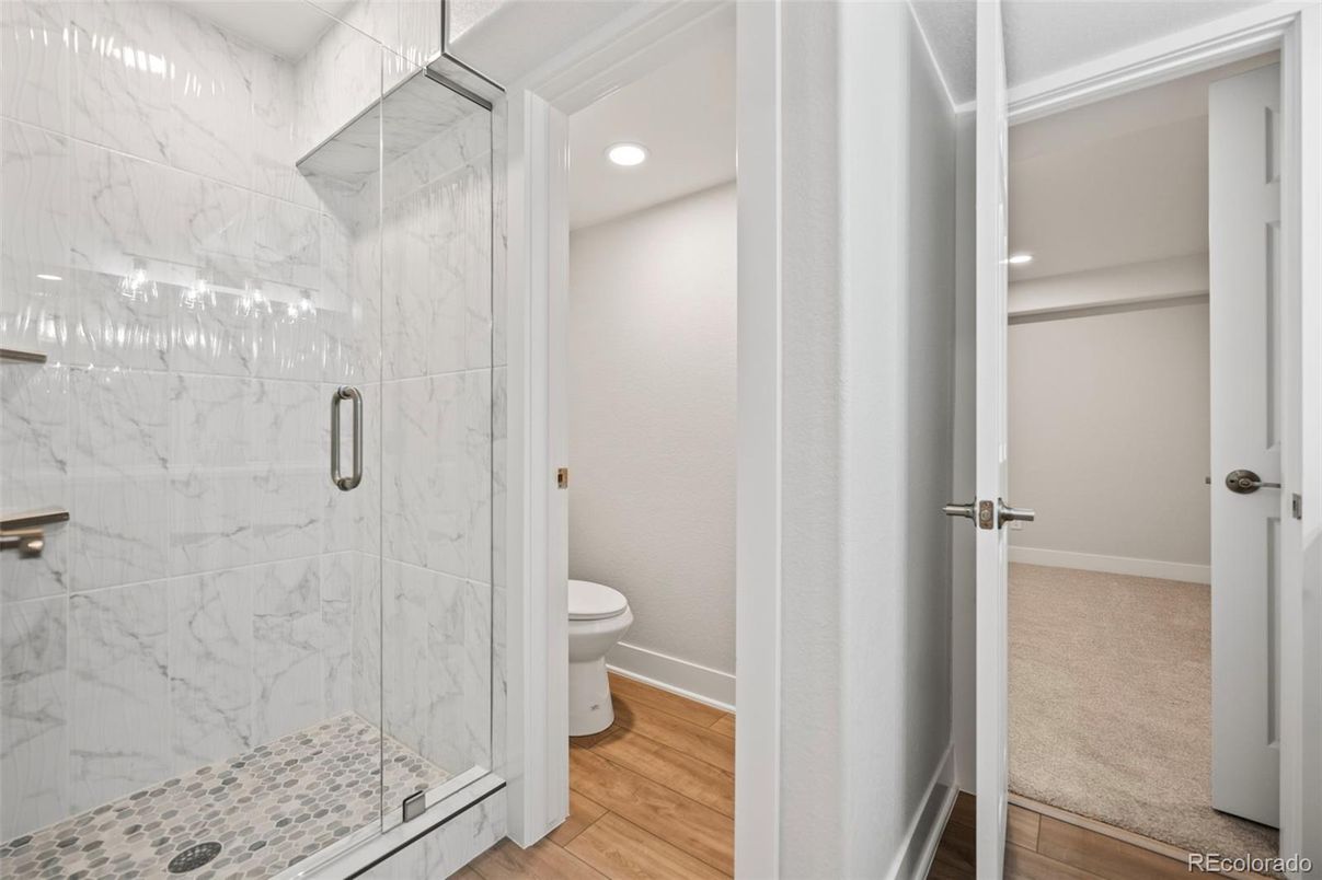 Bathroom, Glass Shower, Interior, Marble Walls, Recessed Lighting, Wood Texture Flooring