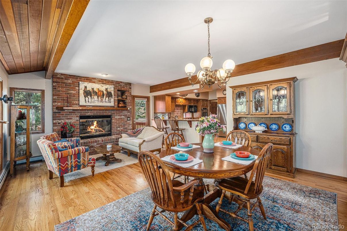 Chandelier, Dining room, Fireplace, Interior, Living room, Recessed Lighting, Stone Walls, Wooden Beams, Wood Texture Flooring