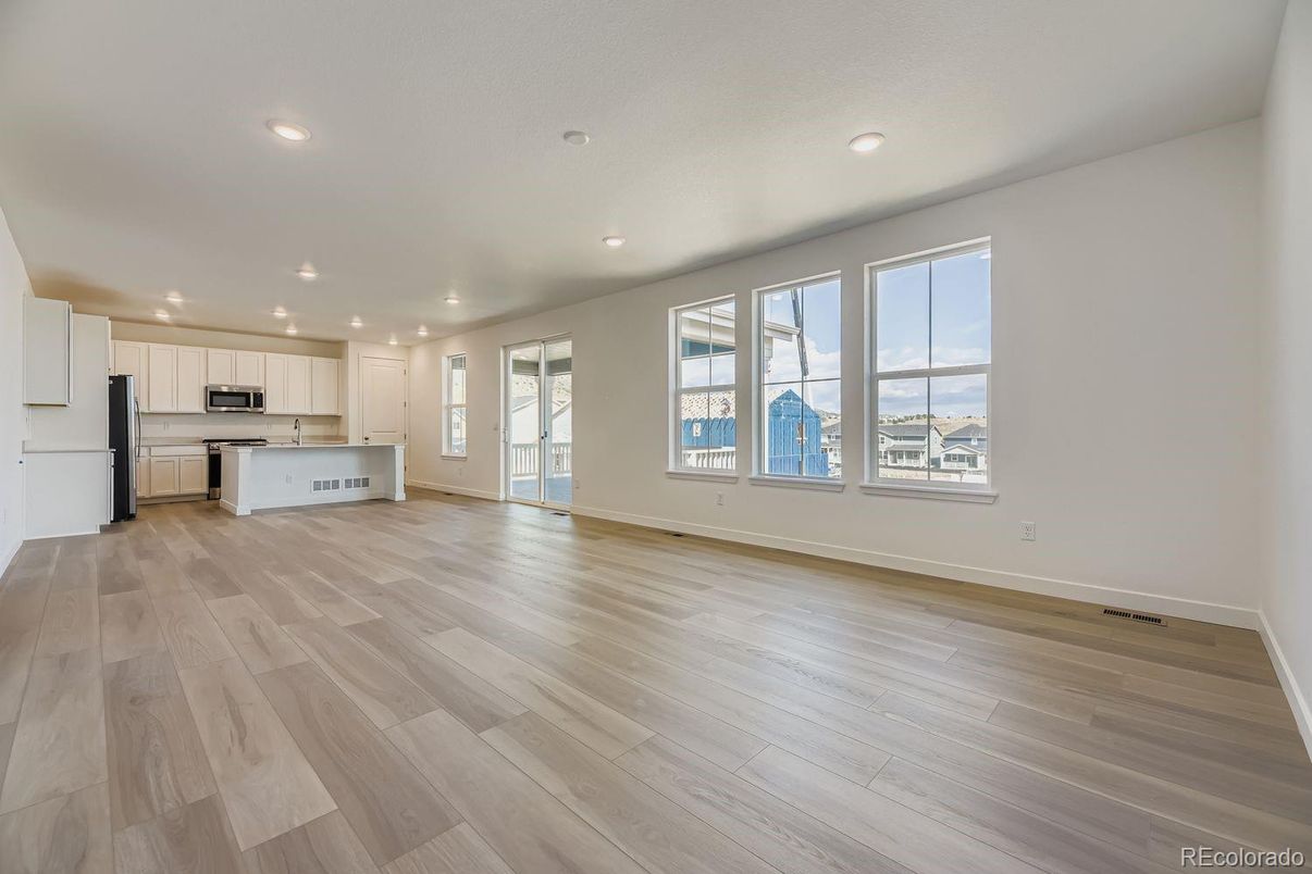 Empty room, Interior, Kitchen, Recessed Lighting, Stainless Steel Appliances, Wood Texture Flooring