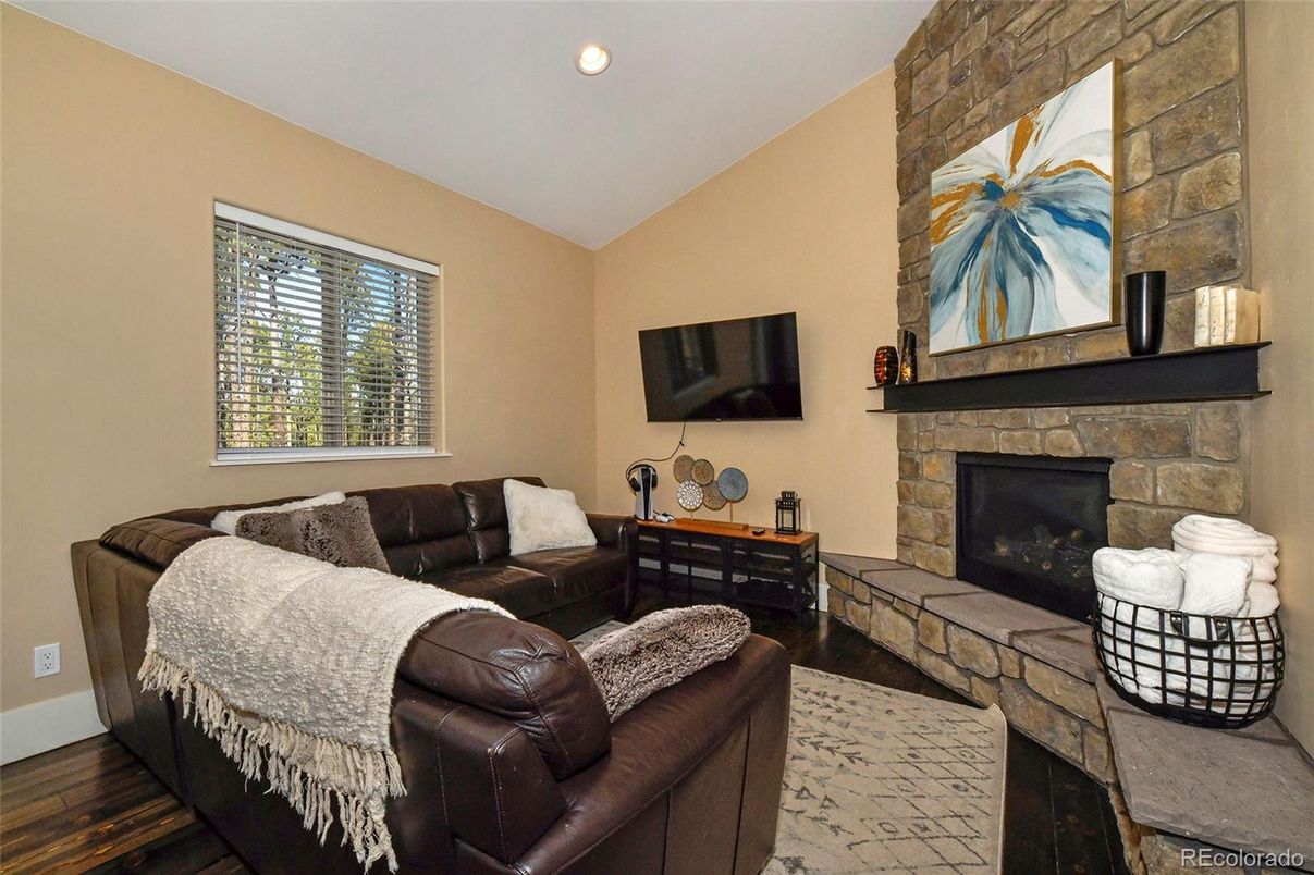 Fireplace, Interior, Living room, Recessed Lighting, Stone Walls, Wood Texture Flooring