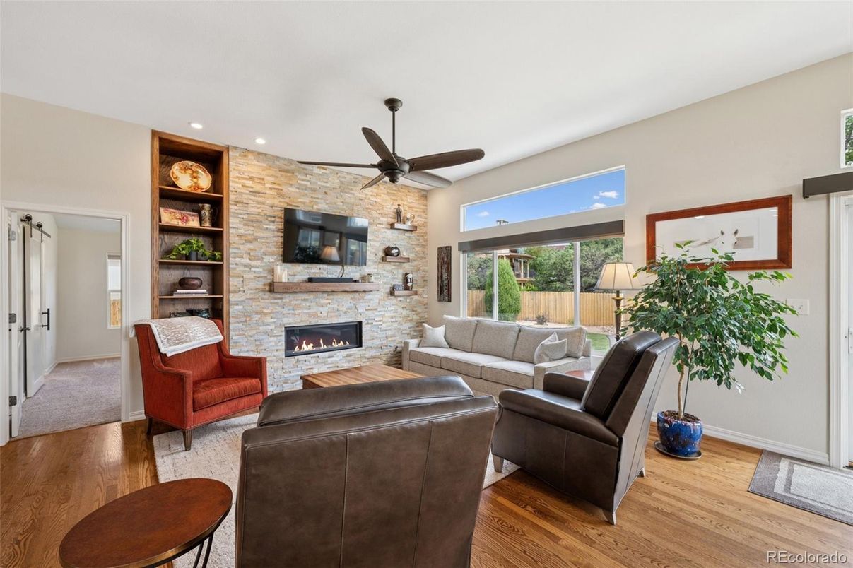 Fireplace, Interior, Living room, Recessed Lighting, Stone Walls, Wood Texture Flooring