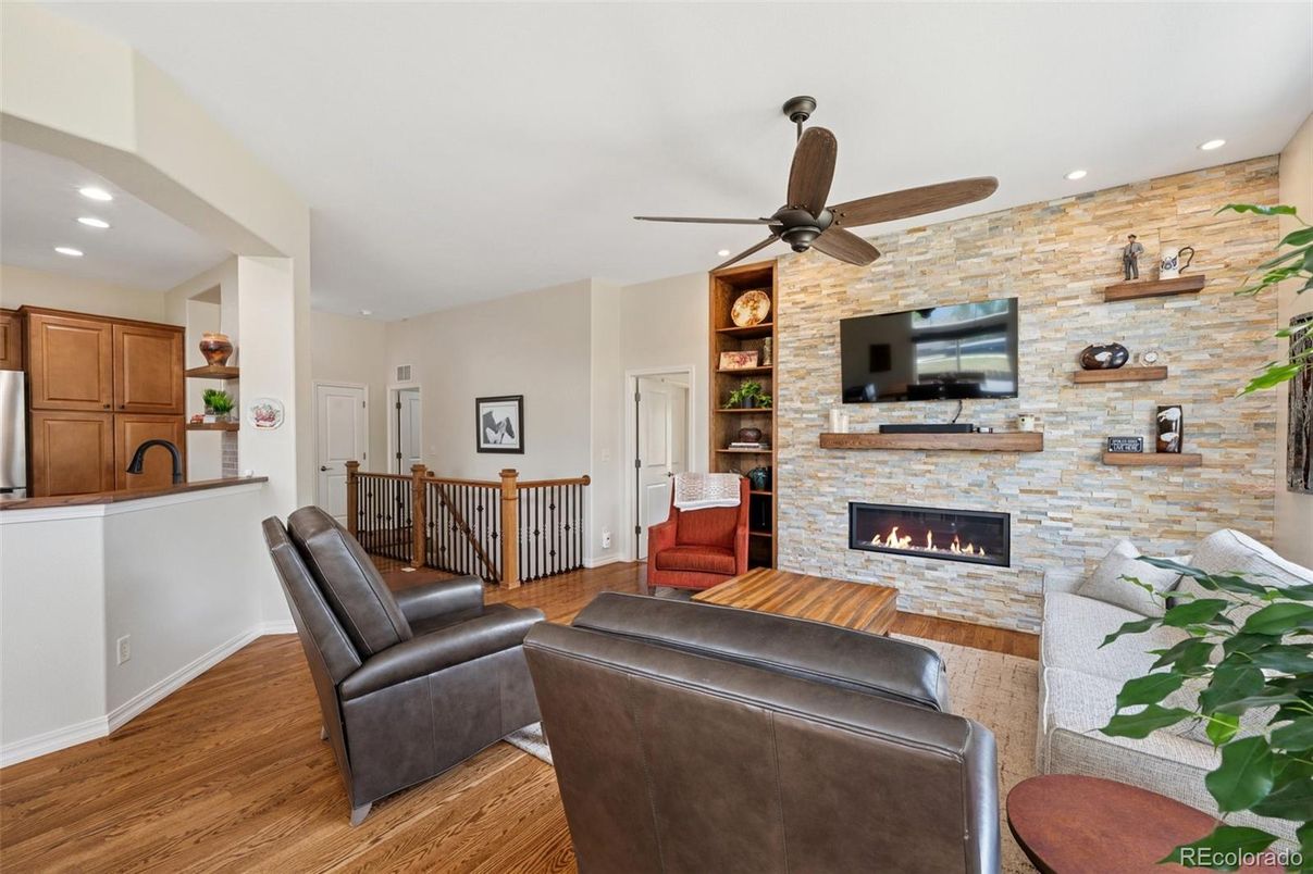 Fireplace, Interior, Living room, Recessed Lighting, Stone Walls, Wood Texture Flooring