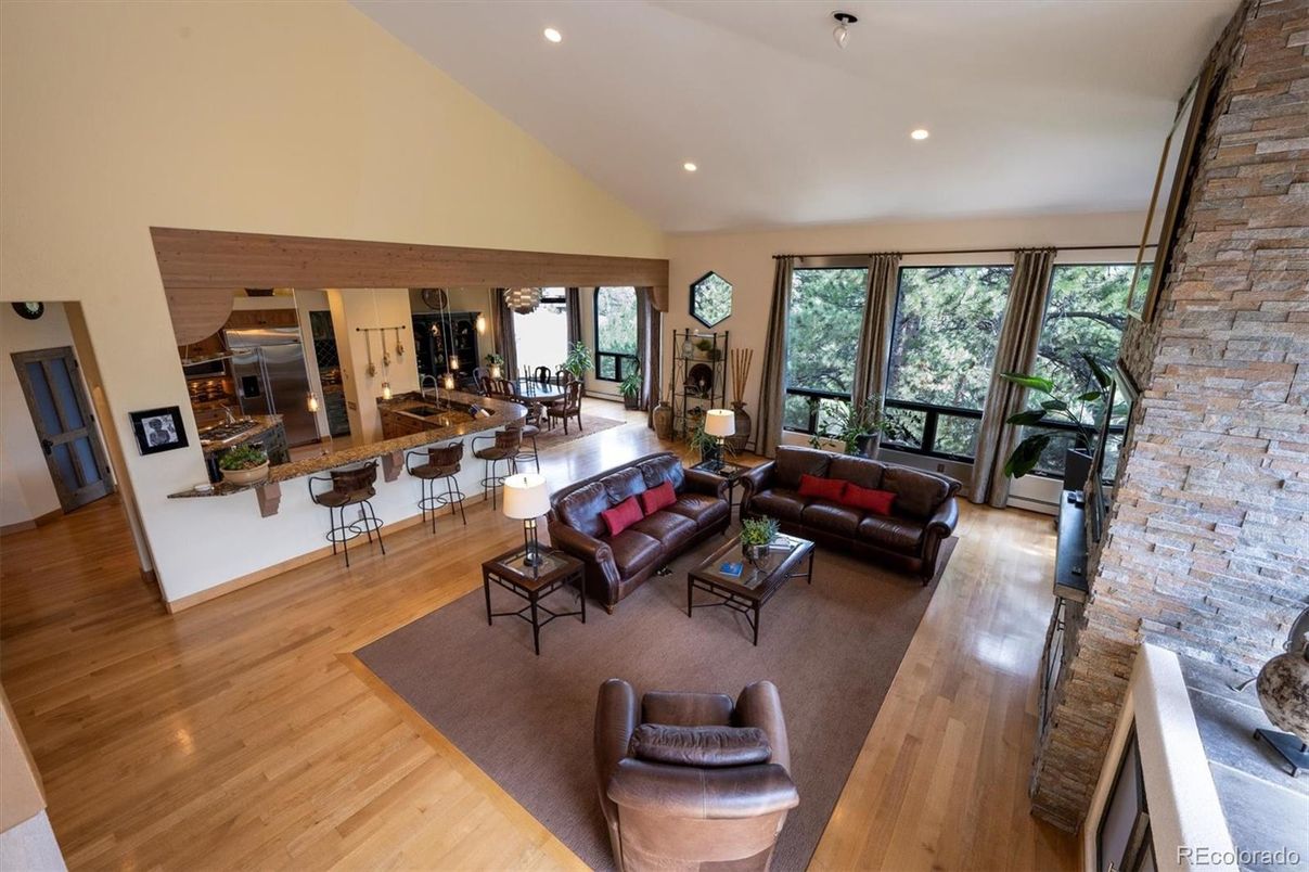 Dining room, Fireplace, Interior, Kitchen, Living room, Recessed Lighting, Stainless Steel Appliances, Stone Walls, Wood Texture Flooring