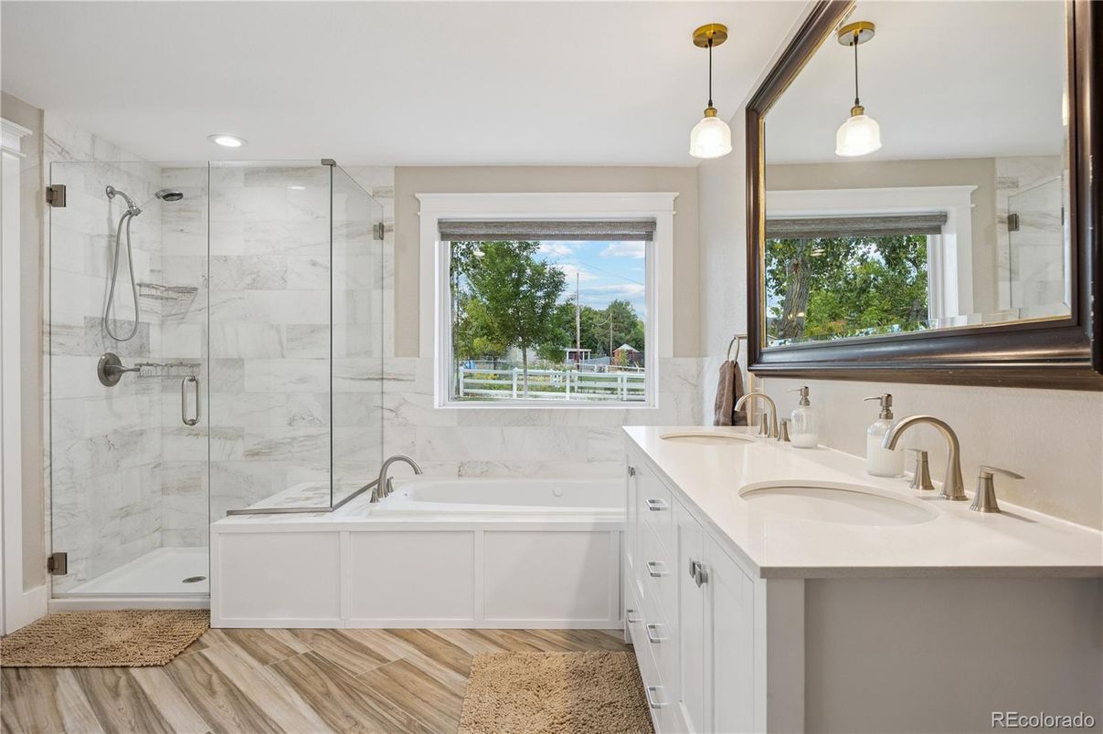 Bathroom, Dual Sink Vanities, Glass Shower, Interior, Marble Walls, Pendant Lights, Recessed Lighting, Wood Texture Flooring