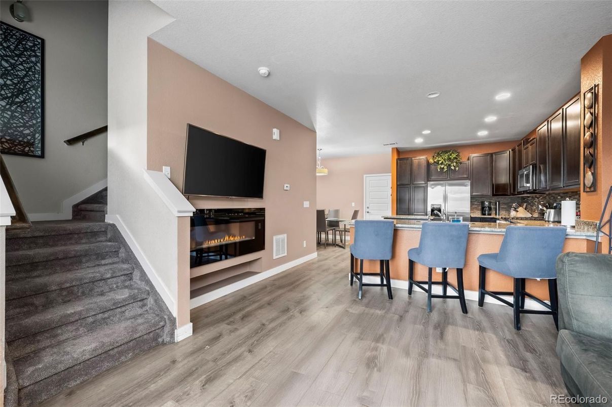 Fireplace, Interior, Kitchen, Recessed Lighting, Stainless Steel Appliances, Wood Texture Flooring