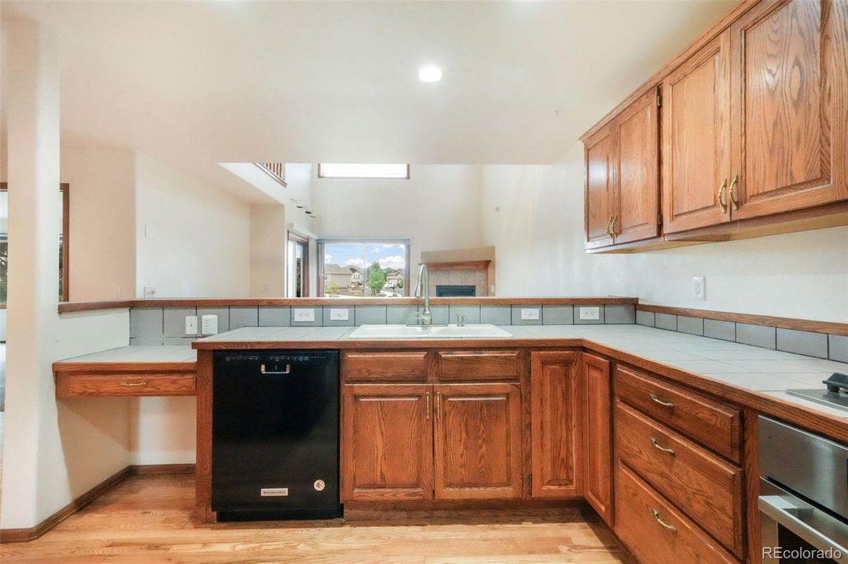 Interior, Kitchen, Recessed Lighting, Tile Countertops, Wood Texture Flooring