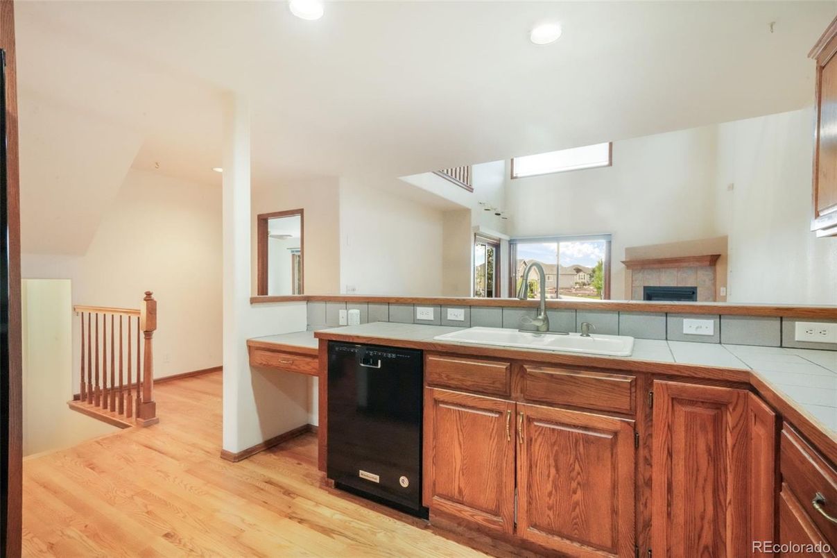 Fireplace, Interior, Kitchen, Recessed Lighting, Tile Countertops, Wood Texture Flooring