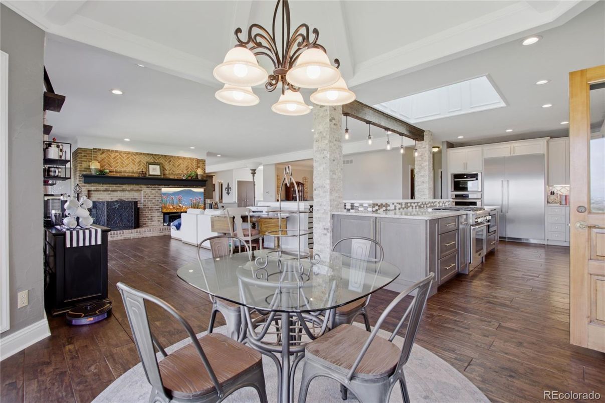 Dining room, Fireplace, Interior, Kitchen, Pendant Lights, Recessed Lighting, Stainless Steel Appliances, Stone Walls, Wood Texture Flooring