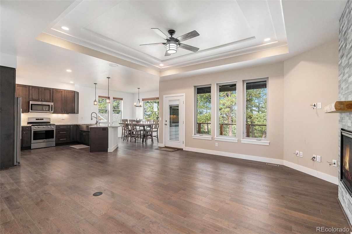 Dining room, Fireplace, Interior, Kitchen, Pendant Lights, Recessed Lighting, Stainless Steel Appliances, Wood Texture Flooring