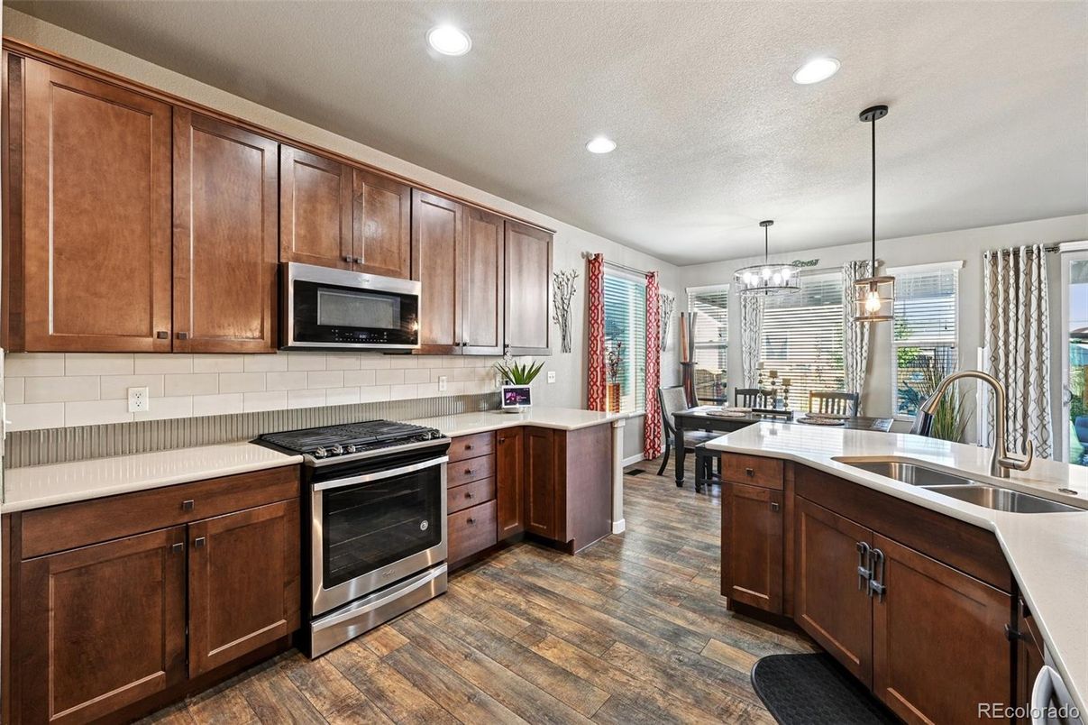 Chandelier, Dining room, Interior, Kitchen, Pendant Lights, Recessed Lighting, Stainless Steel Appliances, Wood Texture Flooring
