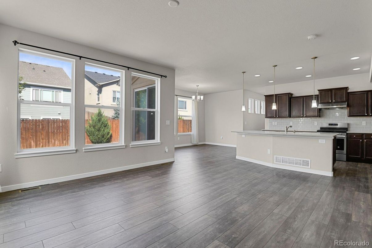 Chandelier, Empty room, Interior, Kitchen, Pendant Lights, Recessed Lighting, Stainless Steel Appliances, Wood Texture Flooring
